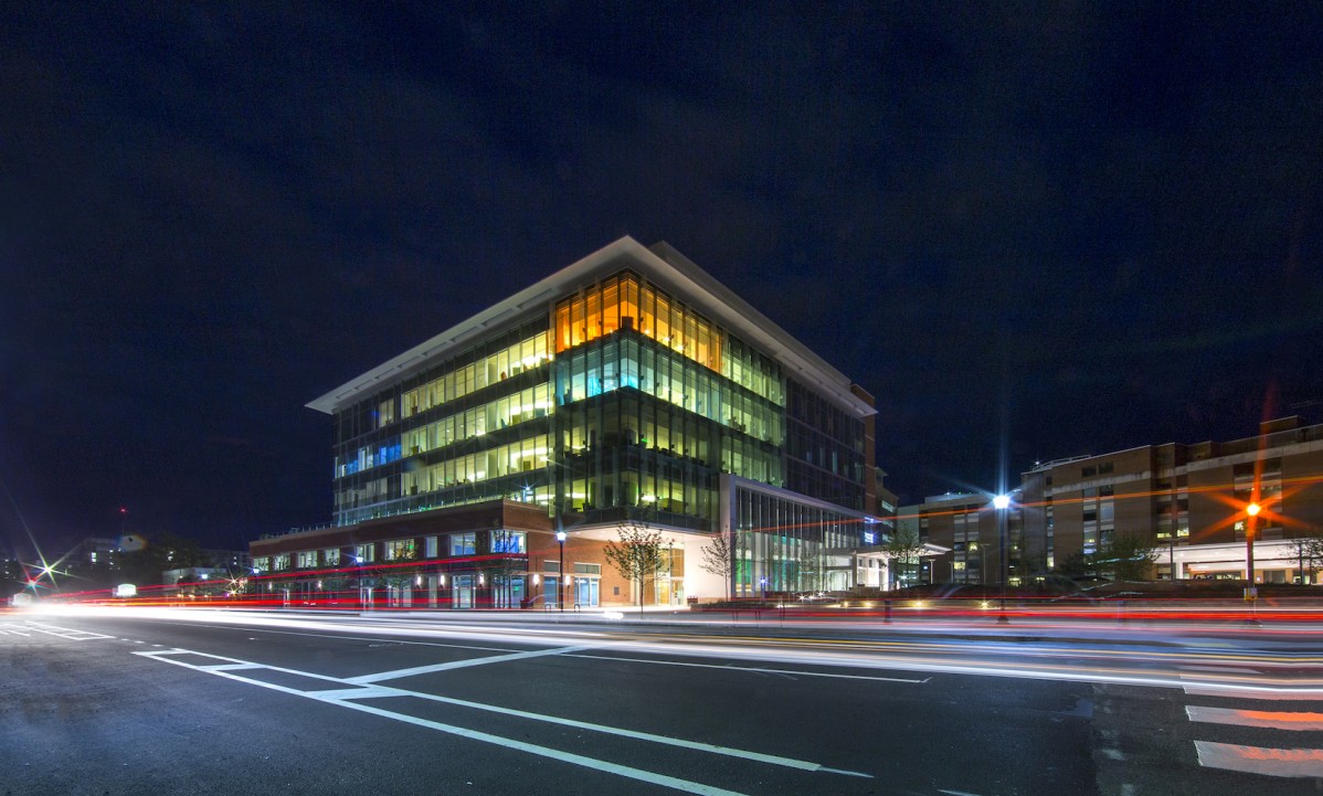 Exterior of a colorfully light multi story building at dusk