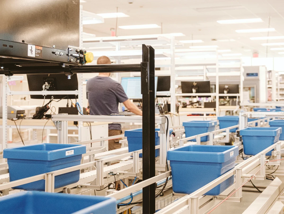 automated pharmaceutical equipment with an operator in the background