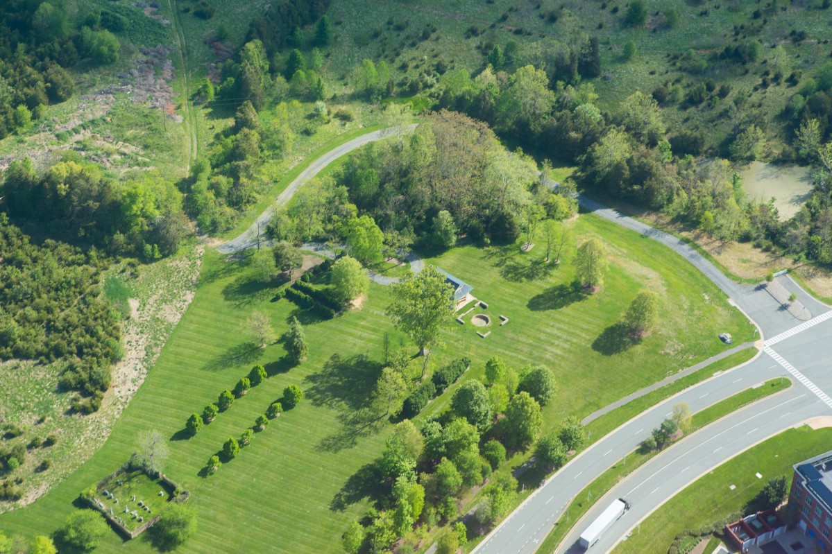 aerial view of an historic picnic pavilion surrounded by green lawn and trees